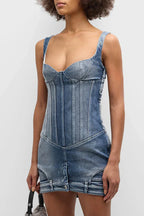 Close-up of the blue denim corset mini dress, showing the paneled bodice and sweetheart neckline.