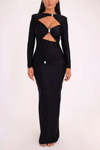 Woman wearing a black long-sleeved maxi dress with a keyhole neckline and cut-out detail.
