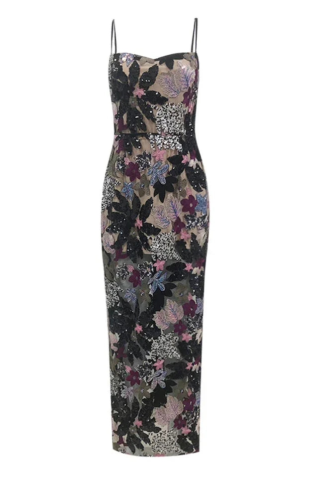Front view of a strapless-style sequined and appliquéd gown with a sheer overlay and a floor-length hem.