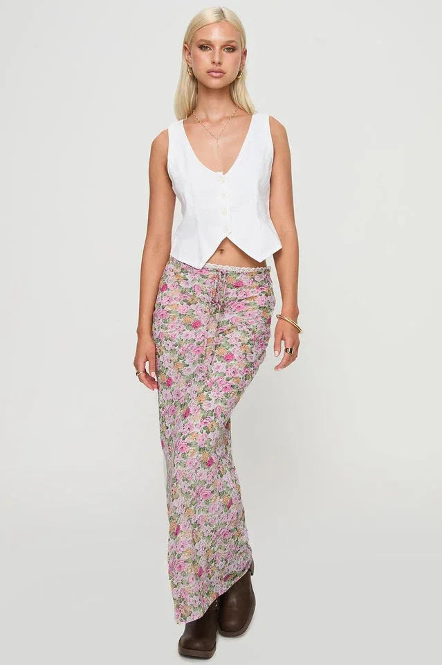 Woman wearing a white V-neck vest and a floral print maxi skirt. Main image