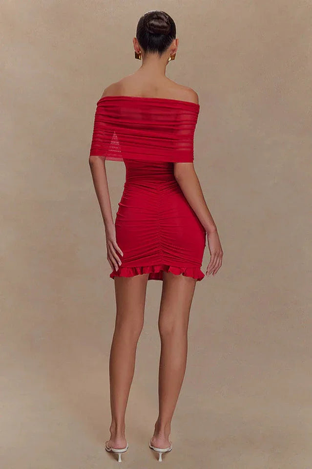Back view of a woman in a red off-the-shoulder ruched dress.