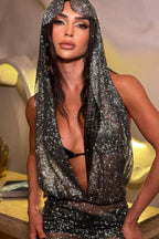 Woman posing in a glamorous outfit with a hooded top