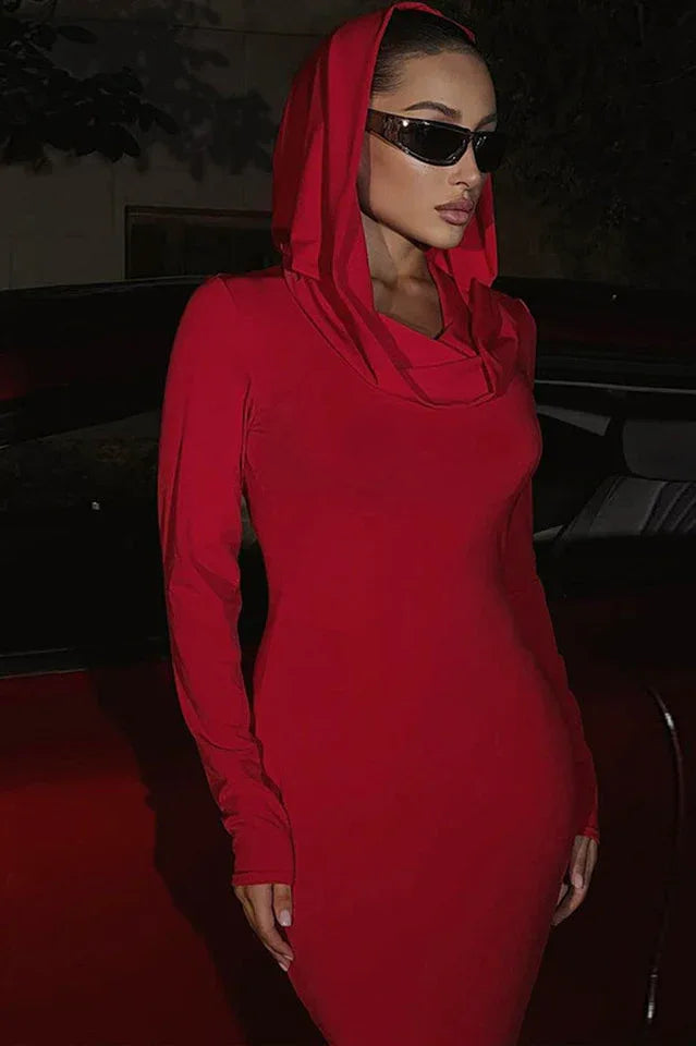 Close-up of a woman's face wearing a red hooded dress and sunglasses.
