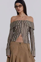 Model wearing an off-the-shoulder striped top and sunglasses