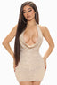 Woman wearing a short, sleeveless, sequined, halter neck dress with a plunging neckline, facing forward.