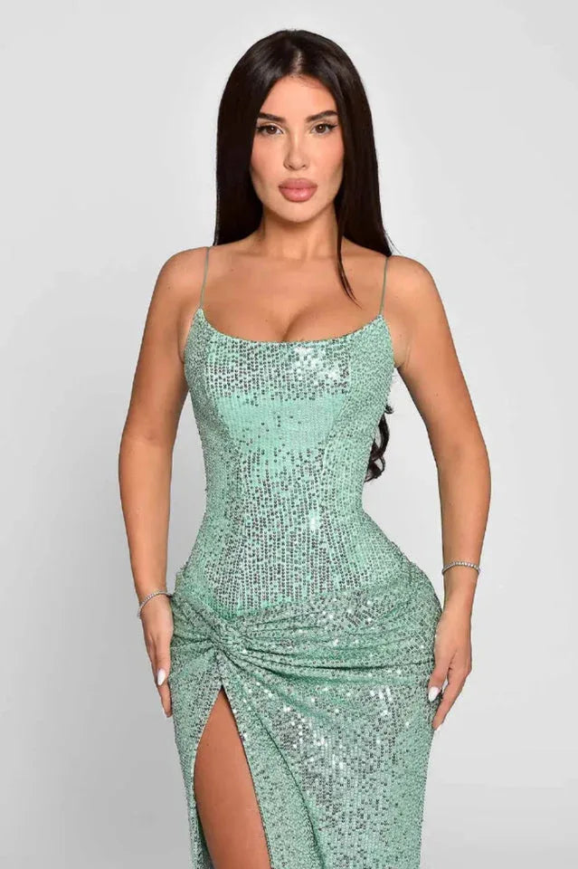 Close-up of a woman in a mint green sequined gown, highlighting the ruched detail and sweetheart neckline.