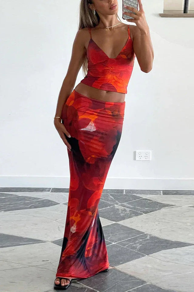 Woman wearing a red floral print crop top and matching maxi skirt Main image