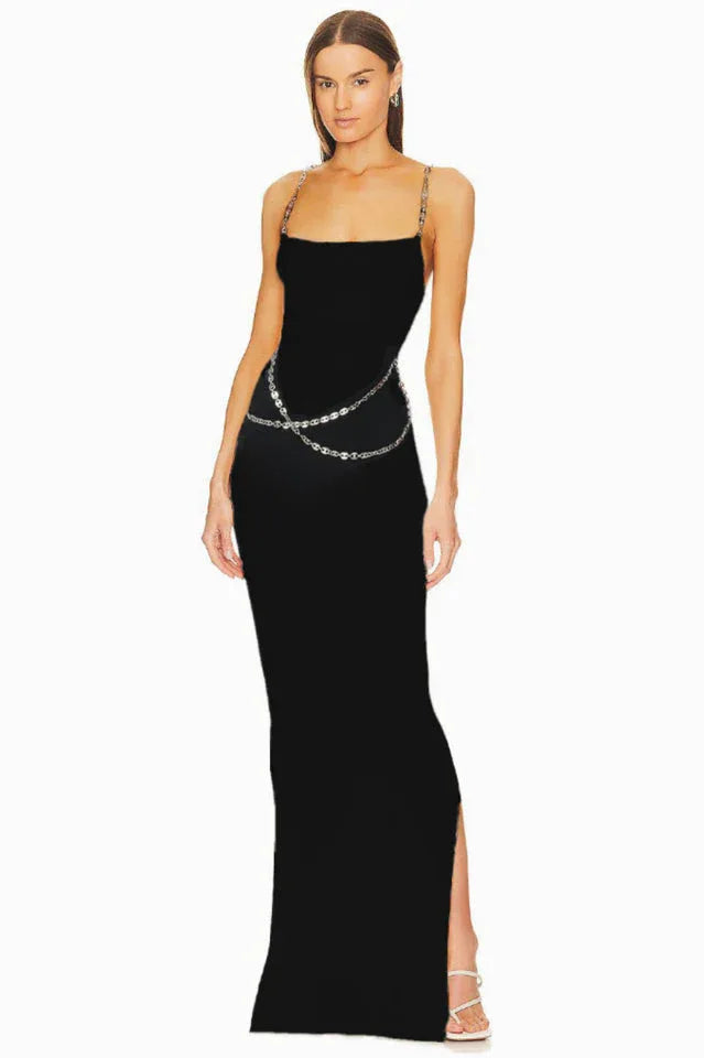 Full-length view of a black sleeveless maxi dress with chain straps and a chain belt.