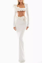 Full length view of a woman wearing a white two-piece formal gown with floral embellishments.