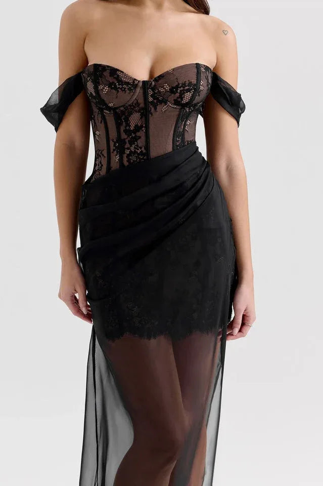 Close-up of the lace detailing on the bodice and skirt of a black off-the-shoulder dress