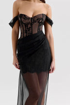 Close-up of the lace detailing on the bodice and skirt of a black off-the-shoulder dress