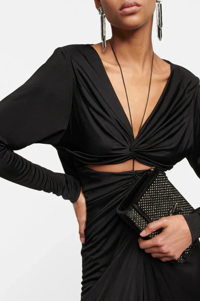 Close-up of the bodice of a black ruched dress with a plunging neckline and cut-out detail