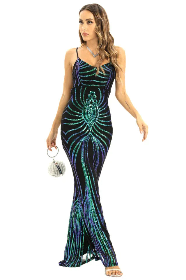 A woman models a black sequined evening gown with a mermaid silhouette and a striking geometric pattern in iridescent green and blue hues.