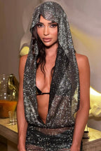 Close-up of a woman in a shimmering hooded garment