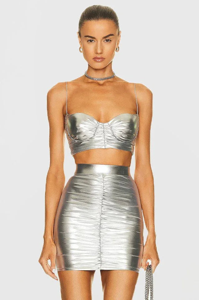 Front view of a woman wearing a silver metallic ruched bustier top and matching ruched mini skirt. Main image