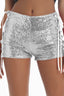 Front view of silver sequined shorts with white lace-up sides.