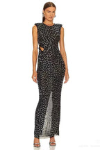 Model wearing a black sleeveless column gown with sequined embellishments and a cut-out detail