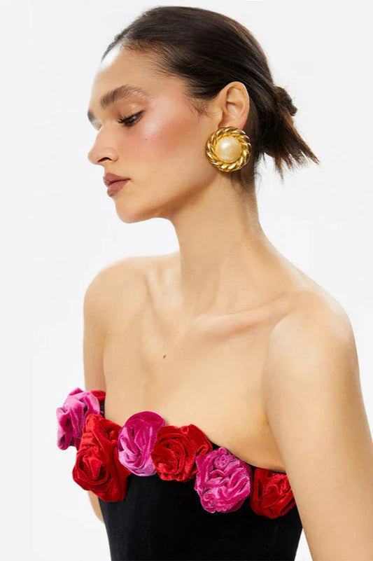 Close-up of the floral embellishments on the black velvet dress.