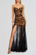 Woman wearing a long black lace dress with a high slit and sweetheart neckline, standing against a white background.