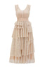 A full-length studio shot of a champagne-colored sparkly tiered gown with a V-neckline and empire waist.
