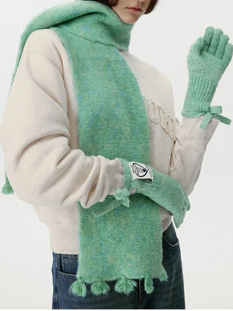 Model wearing a mint green fuzzy scarf and matching gloves