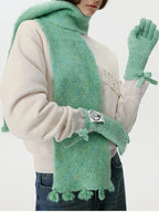 Model wearing a mint green fuzzy scarf and matching gloves
