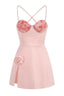 A front view of a pink mini dress with a sweetheart neckline, floral applique, and a high slit.