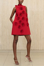 Front view of a red sleeveless A-line mini dress with appliqué roses on the front, worn by a model with white heeled sandals.
