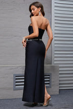 Close-up of the embellished neckline and strapless design of a black evening gown.