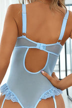 Back view of a light blue lace and mesh bodysuit showing closure and cut-out detail