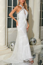 Elegant white sequined dress with a halter neckline and a train, worn by a model.