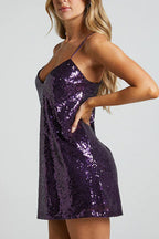 Side view of a woman in a purple sequin slip dress, showing the fit.