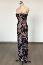 Side view of a strapless, sequined floral dress on a mannequin. The gown has a fitted silhouette and intricate detailing.