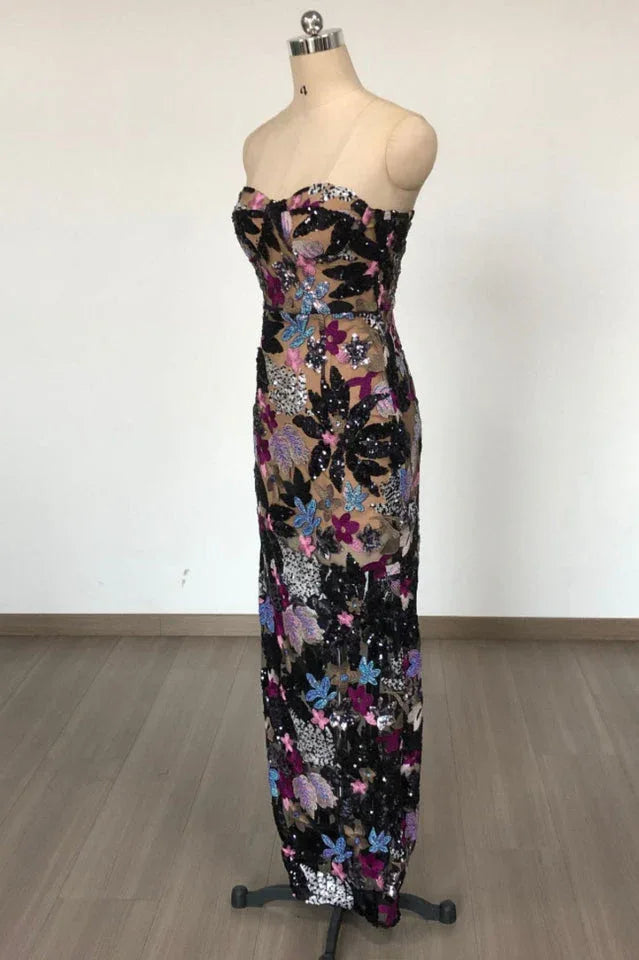 Side view of a strapless, sequined floral dress on a mannequin. The gown has a fitted silhouette and intricate detailing.