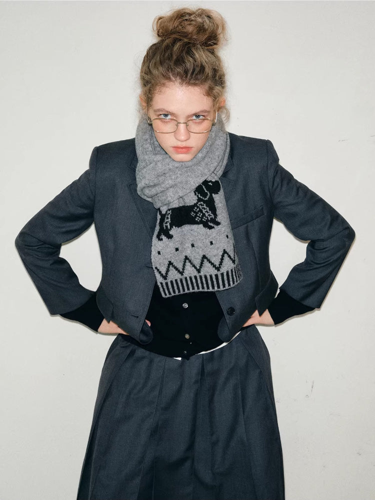 Model posing with hands on hips, wearing a gray suit and a dachshund scarf.