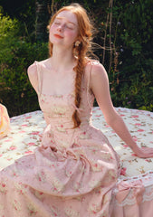 Back view of a pink floral print midi dress with a corset lace-up detail