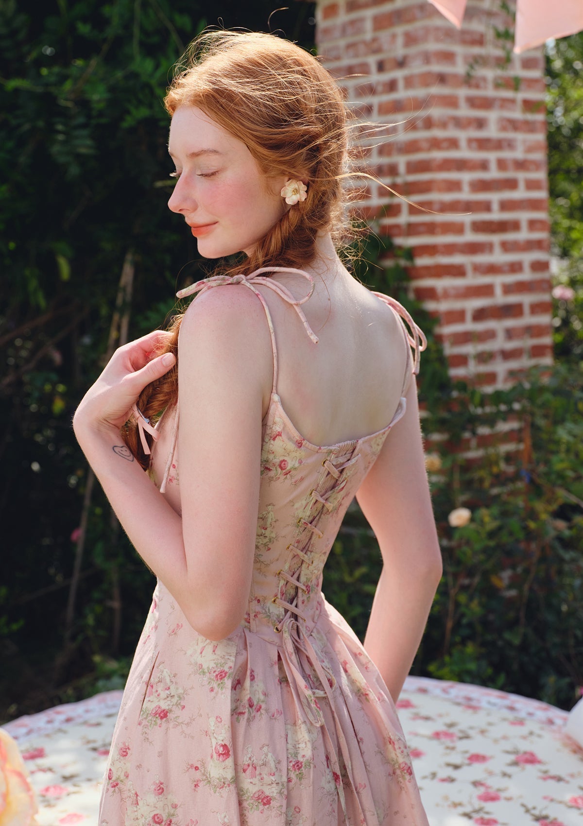 Full length view of the pink floral print midi dress on a white background