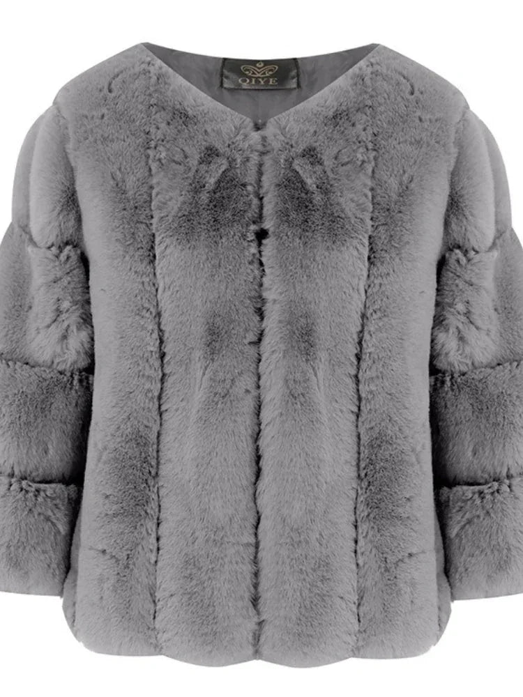 Front view of a grey faux fur jacket with an open neckline and layered sleeves.