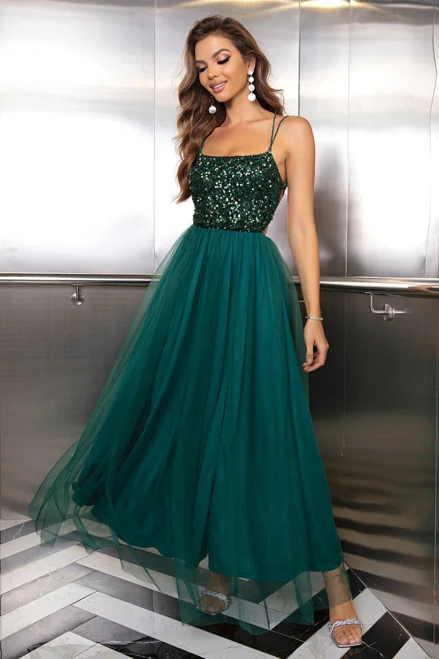 woman in a dark green sequined and tulle evening gown