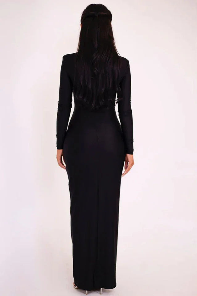 Back view of a woman wearing a black long-sleeved maxi dress.