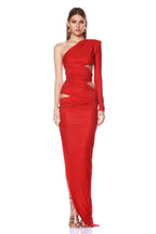 Full-length studio shot of a woman in a red one-shoulder sparkly dress with cut-outs and an asymmetrical hem.