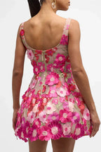 Back view of a sleeveless floral mini dress, showing a zip closure at the center back and the intricate placement of flower embellishments.