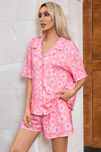 Close-up of a woman in a pink floral print pajama set, showing the button-down top.