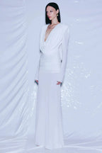 Full-length view of a white draped gown on a mannequin.