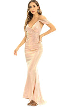 Side view of a woman in a pink sequined formal gown with an off-the-shoulder design and mermaid hemline.