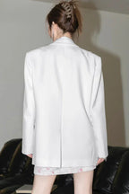 Back view of a white blazer.