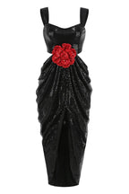 Full view of a black sequined gown with a sweetheart neckline, cut-out waist, and draped skirt.