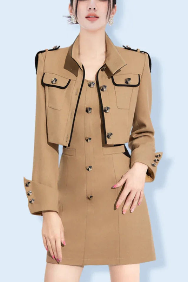 Woman wearing a beige cropped jacket and matching mini dress with decorative buttons and black trim Main image