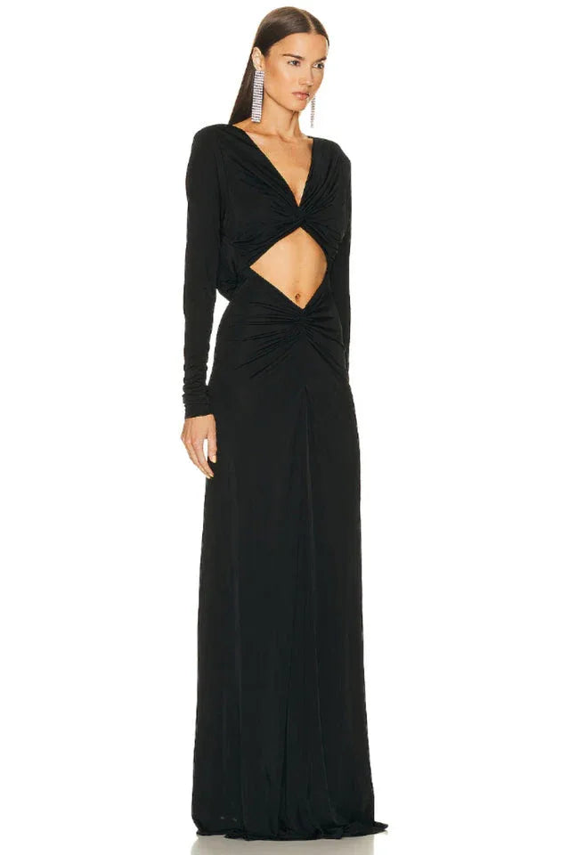 Full-length view of a black ruched maxi dress with a cutout