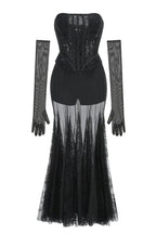 Black lace corset gown with sheer skirt and long sleeves laid flat